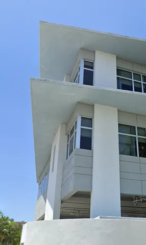 RECO Island facility exterior surrounded by tropical landscaping in Delray Beach